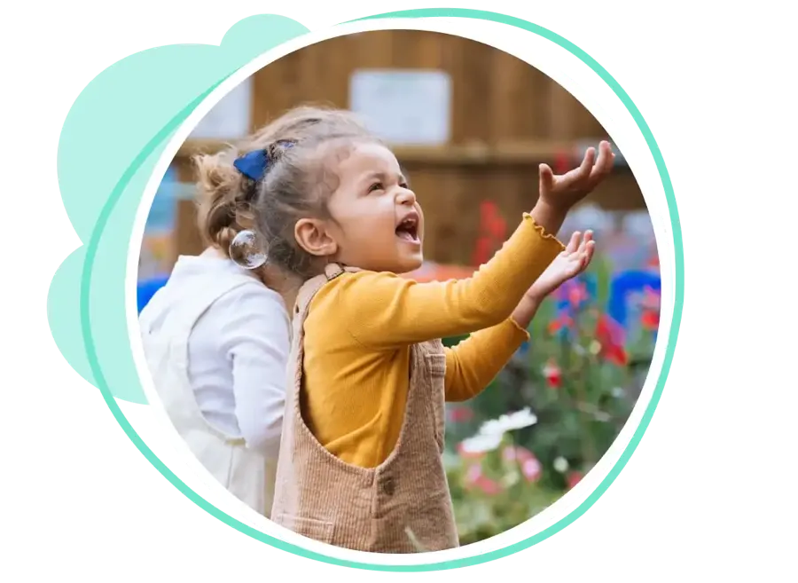 A child playing joyfully at a tiney setting