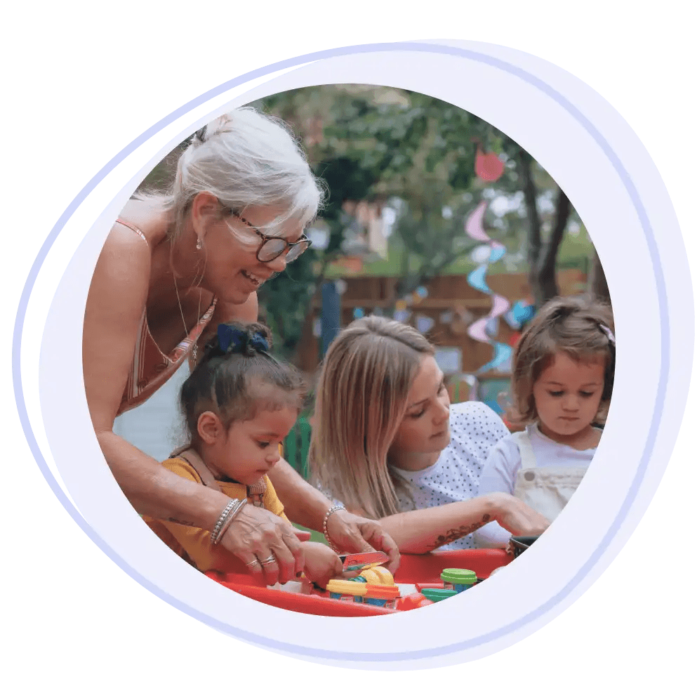 A tiney childminder playing with a small group of children